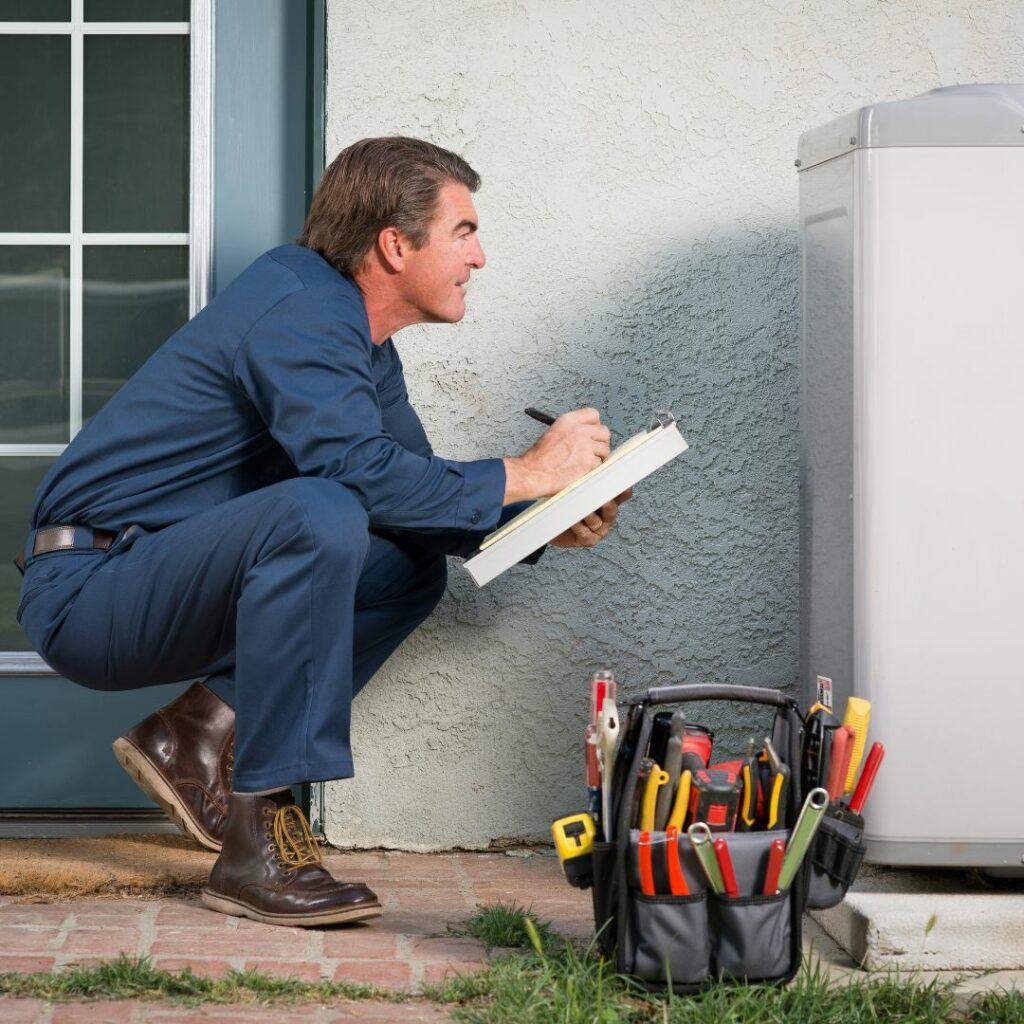 AC Repair technician examining a AC Unit