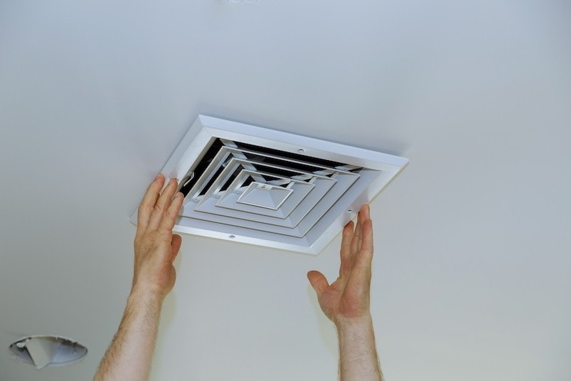 HVAC Technician Inspecting Air Vent - AC Installation Process: What to Expect