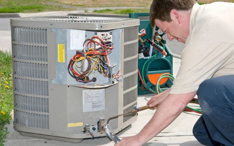 Man repairing an AC Unit